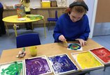 Girl working on a painting at school.